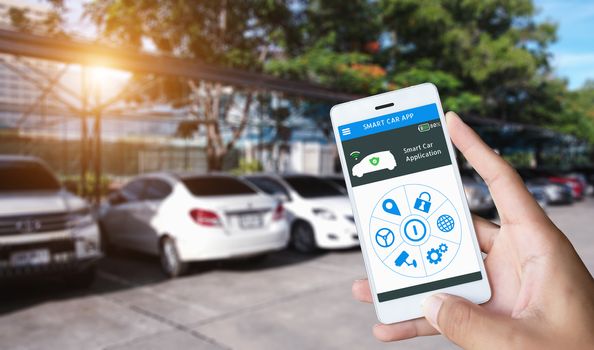 Auto parking and Smart pick me up application, Auto drive function and internet of things in smart car concept. Hand holding smart phone and application dashboard with blur car parking background.