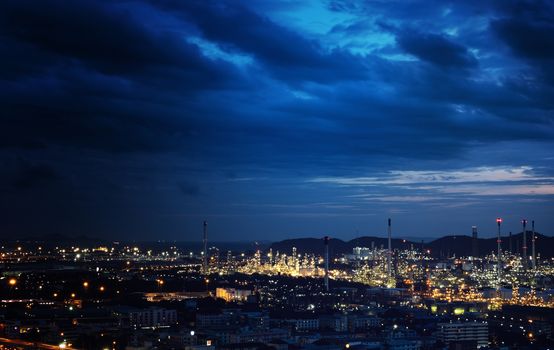 The industrial at the night. Beautiful light from the industrial and dark blue cloud.