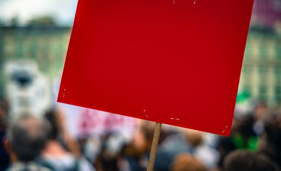 A Blank Red Sign For Your Text At A Street Rally Or Protest Or March