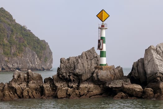 Small lighthouse on a rock in Ha Long bay, Vietnam