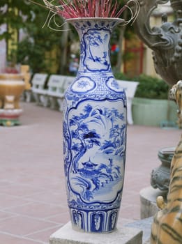 Traditional Chinese blue-and-white ceramic incense burner at the entrance of a temple