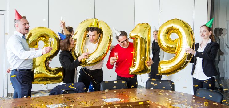 Business people celebrating 2019 New Year at office party