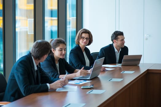 Image of business partners discussing documents and ideas at meeting