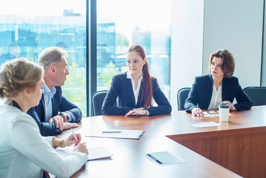 Image of business partners discussing documents and ideas at meeting