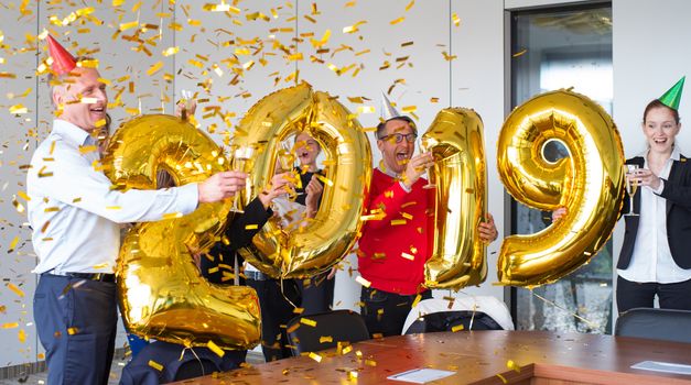 Business people celebrating 2019 New Year at office party