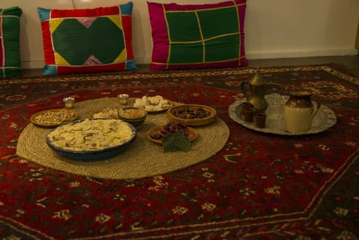 spcial made moslim food for the end of the ramadan, with sweet and grapes and thee to drink, on a carpet on the floor