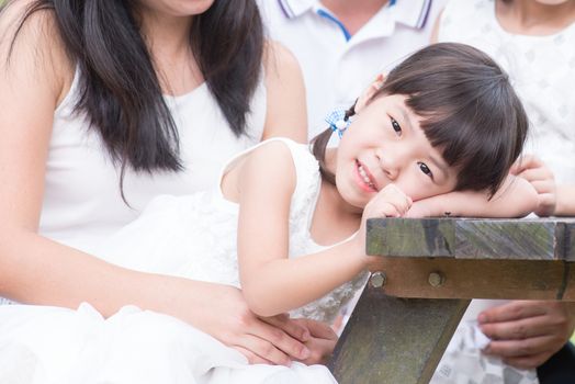 Asian family portrait. Parents and children at outdoor park. 