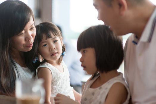 Candid shoot of people in cafeteria. Little girl with various face expression. Asian family outdoor lifestyle with natural light.