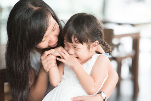 Candid shoot of people in cafeteria. Little girl with various face expression. Asian family outdoor lifestyle with natural light.