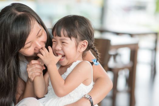 Candid shoot of people in cafeteria. Little girl with various face expression. Asian family outdoor lifestyle with natural light.