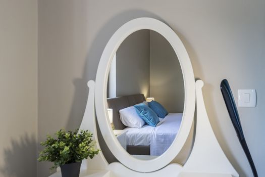 comfortable bed reflected in the mirror