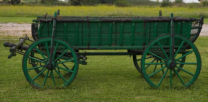 Old rustic vintage carriage in yard, side view