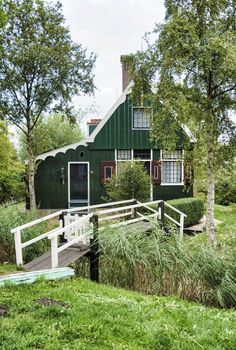 Zaandam,Holland,28-aug-2018:old green wooden houses from few hundred years oldstill  original and still inhabited, with a green bridge over the small rivers. this part is called zaanmse schans