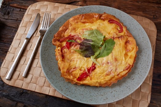 Omelet with green onion on wood table. Fresh ingredient of egg and onion. Delicious dish. Easy to cook. Popular in Thailand food. Still life food.