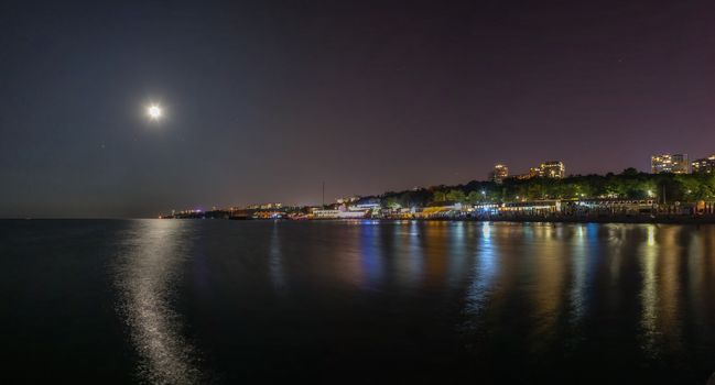 ODESSA, UKRAINE - 08.22.2018. Panoramic view of Langeron city beach in a hot summer night. The most popular beach in Odessa