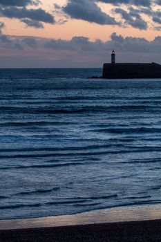 Newhaven Lighthouse and Seaford Beach at sunset