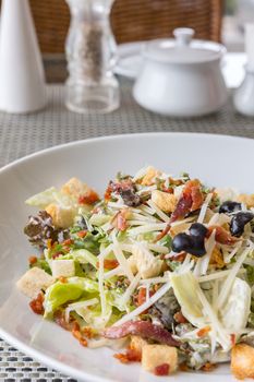 Caesar salad with bacon and chicken, mediterranean cuisine