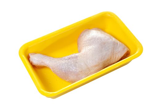Raw chicken thigh in plastic container isolated on white background with clipping path. One chicken leg