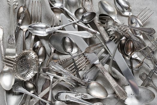 Various silverware on a background of gray linen fabric