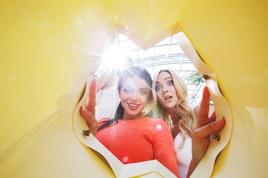 beautiful young women looking inside bag