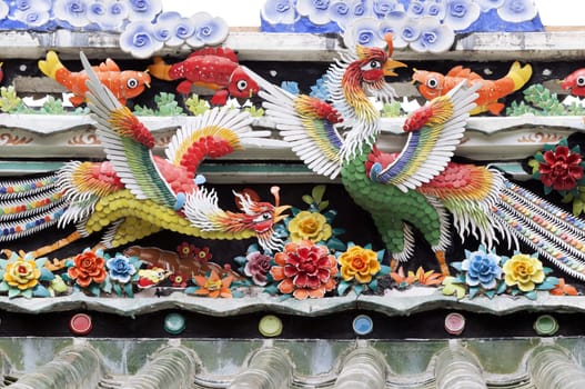 Decoration of a Vietnamese temple roof, birds and fish