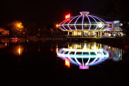 Night city landscape. City ponds Khabarovsk in the light of lanterns, which are reflected in the water.