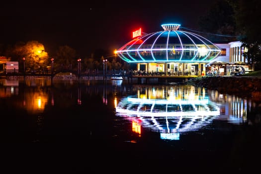 Night city landscape. City ponds Khabarovsk in the light of lanterns, which are reflected in the water.