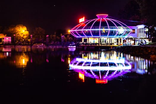 Night city landscape. City ponds Khabarovsk in the light of lanterns, which are reflected in the water.