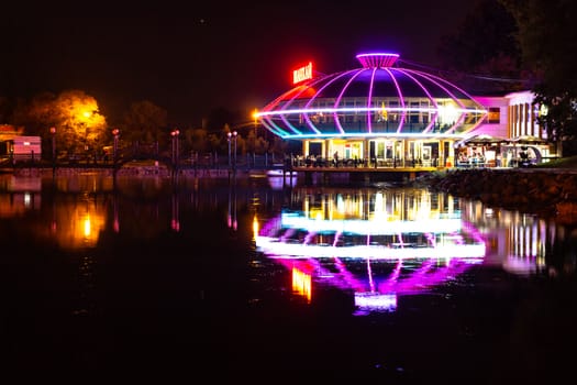 Night city landscape. City ponds Khabarovsk in the light of lanterns, which are reflected in the water.