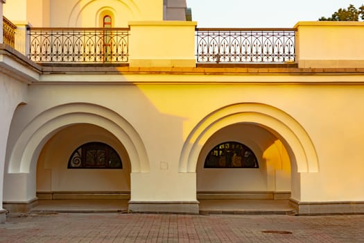 Beautiful view during sunset at the temple of St. Seraphim of Sarov in the city of Khabarovsk. A beautiful green lawn in the foreground. Religious architecture, buildings and traditions. Russia.