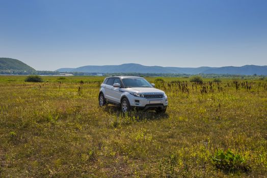 Car Land Rover Range Rover is in the field on a Sunny autumn day near the city of Samara, Russia. August 1, 2018.