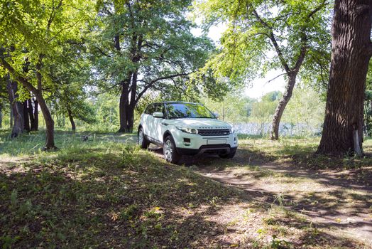 Car Land Rover Range Rover in summer Sunny weather in the summer landscape of the Samara region, Russia. August 21, 2018.