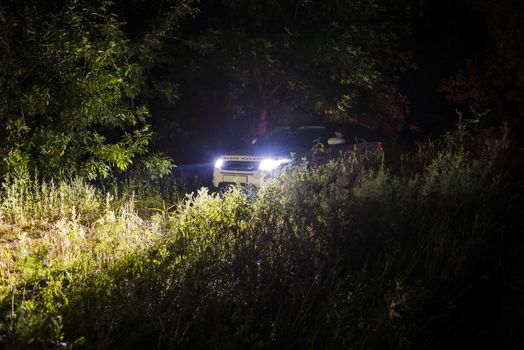 Car Land Rover Range Rover in the summer clear weather in the evening landscape of the Samara region, Russia. August 23, 2018..