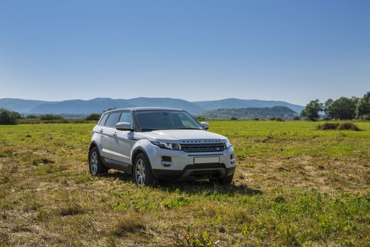 Car Land Rover Range Rover is in the field on a Sunny autumn day near the city of Samara, Russia. August 1, 2018.