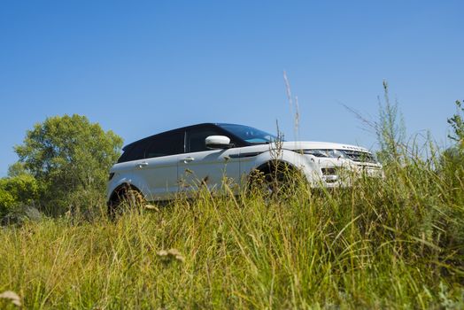 Car Land Rover Range Rover in summer Sunny weather in the summer landscape of the Samara region, Russia. August 21, 2018.