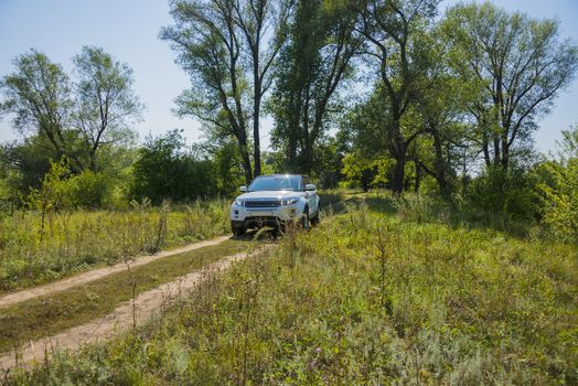 Car Land Rover Range Rover in summer Sunny weather in the summer landscape of the Samara region, Russia. August 21, 2018.