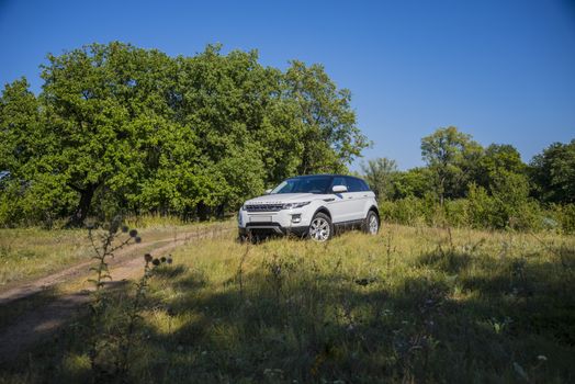 Car Land Rover Range Rover in summer Sunny weather in the summer landscape of the Samara region, Russia. August 21, 2018.