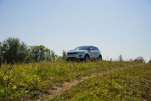 Car Land Rover Range Rover in summer Sunny weather in the summer landscape of the Samara region, Russia. August 21, 2018.