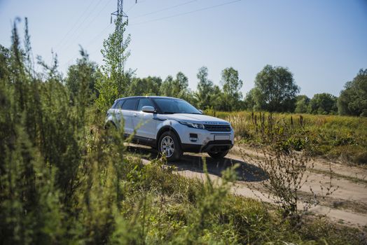 Car Land Rover Range Rover in summer Sunny weather in the summer landscape of the Samara region, Russia. August 21, 2018.