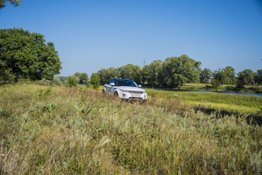 Car Land Rover Range Rover in summer Sunny weather in the summer landscape of the Samara region, Russia. August 21, 2018.