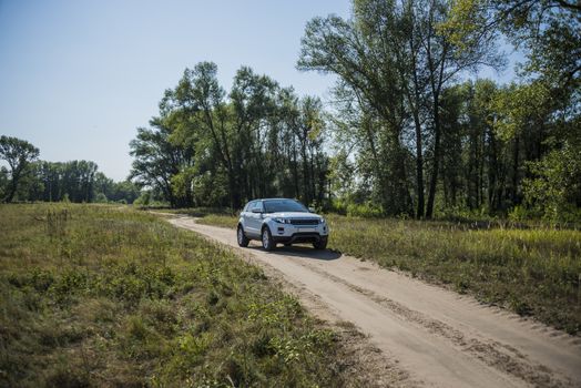 Car Land Rover Range Rover in summer Sunny weather in the summer landscape of the Samara region, Russia. August 21, 2018.