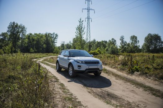 Car Land Rover Range Rover in summer Sunny weather in the summer landscape of the Samara region, Russia. August 21, 2018.