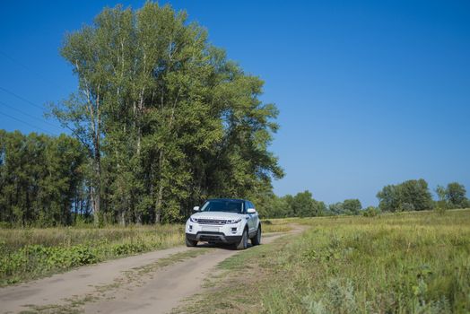 Car Land Rover Range Rover in summer Sunny weather in the summer landscape of the Samara region, Russia. August 21, 2018.