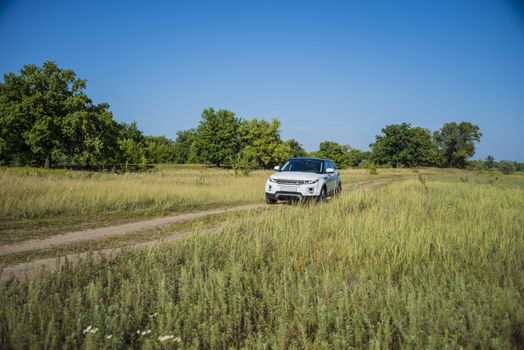 Car Land Rover Range Rover in summer Sunny weather in the summer landscape of the Samara region, Russia. August 21, 2018.