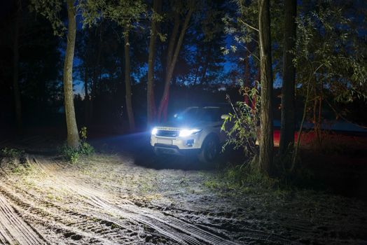 Car Land Rover Range Rover in the summer clear weather in the evening landscape of the Samara region, Russia. August 23, 2018..