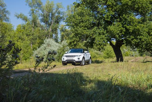 Car Land Rover Range Rover in summer Sunny weather in the summer landscape of the Samara region, Russia. August 21, 2018.