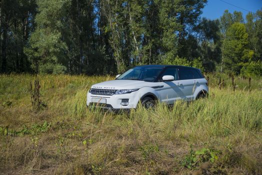 Car Land Rover Range Rover in summer Sunny weather in the summer landscape of the Samara region, Russia. August 21, 2018.