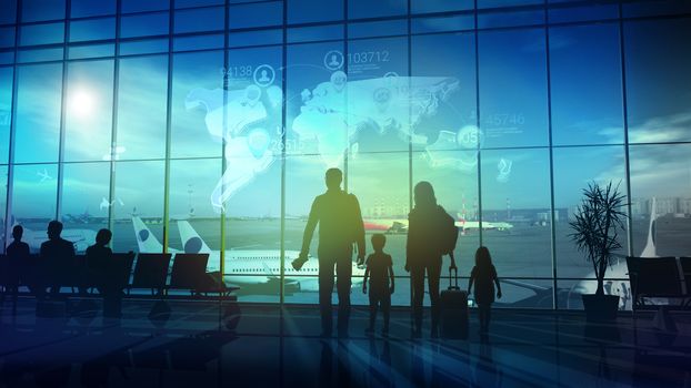 Silhouettes of the family stand in front of a large window in the airport departure hall before a big trip.