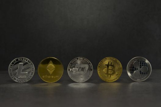 a litecoin and ethereum and dash and bitcoin and ripple together for a black background ,Coins of the four crypto currencies with the highest market capitalization
