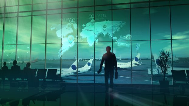 Silhouette of a businessman standing by the window at the airport before the flight.